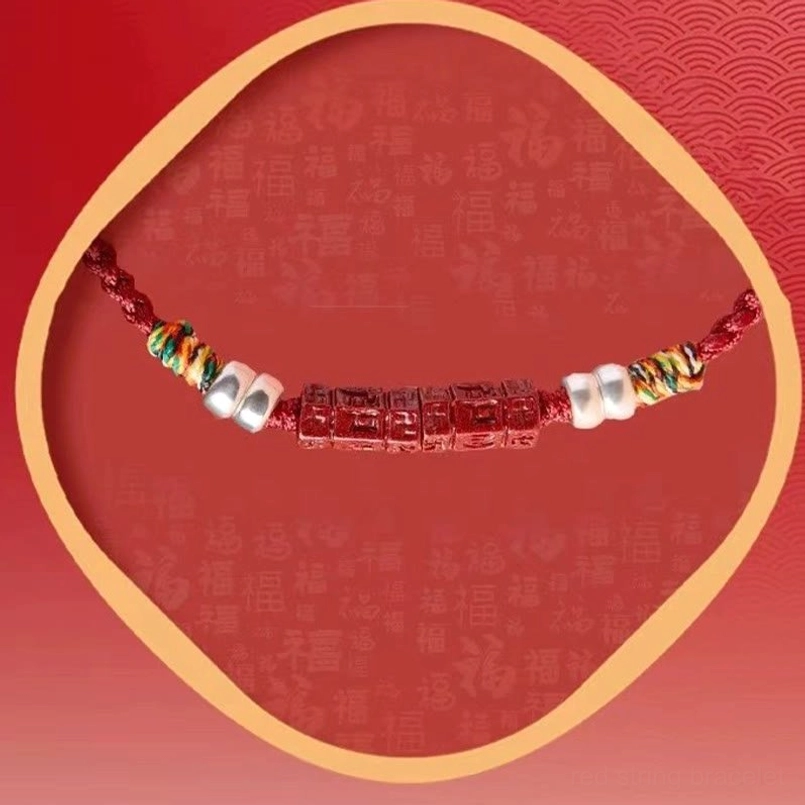 Red string karma bracelet with carved cinnabar bead and protective spiritual symbolism