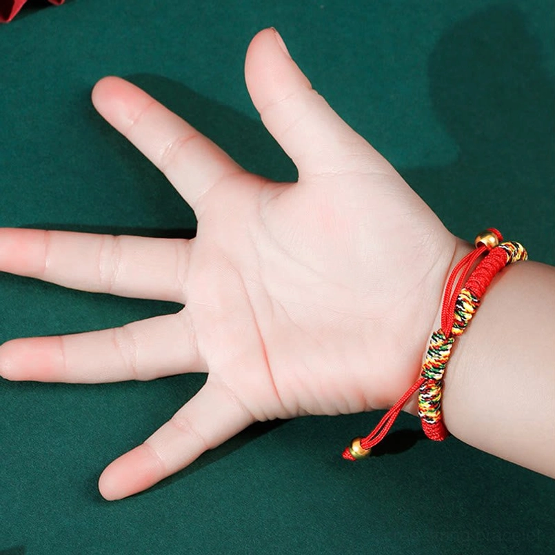 Kids adjustable braided bracelet front view with red and multicolor woven cotton cord