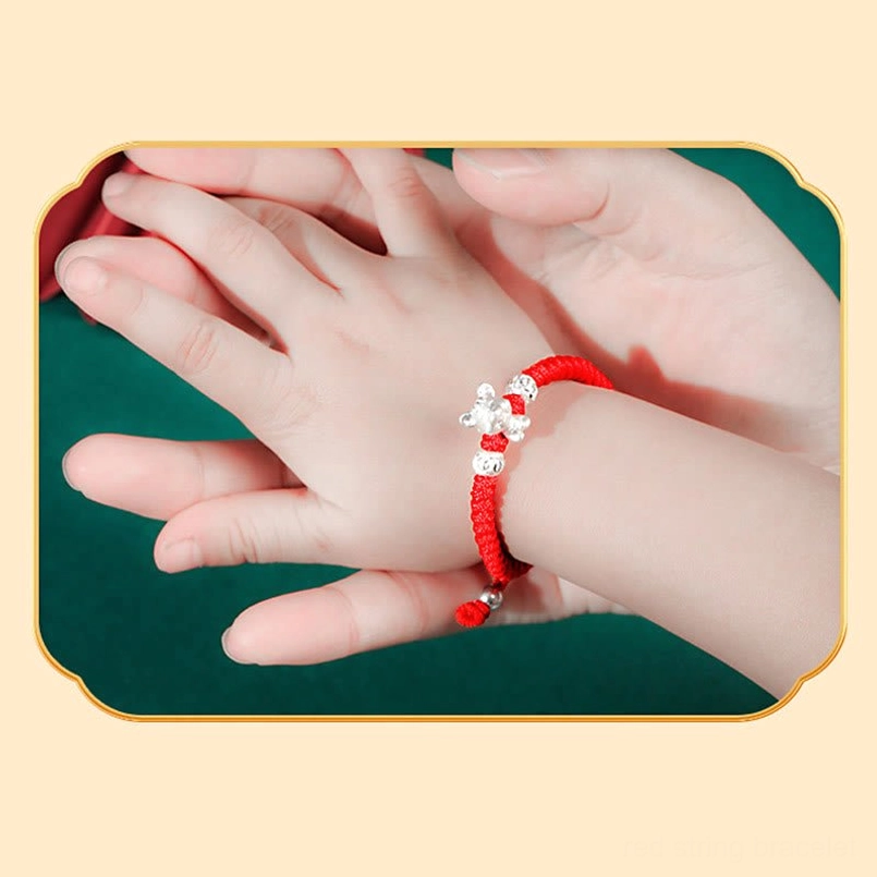 Kids zodiac 999 sterling silver red woven rope bracelet on child wrist side view with warm lighting