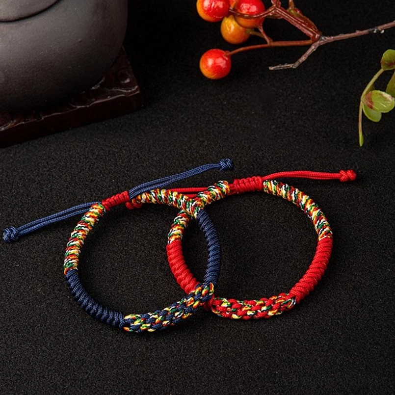 Two King Kong Knot bracelets in red and navy blue variants with multicolor accents displayed together