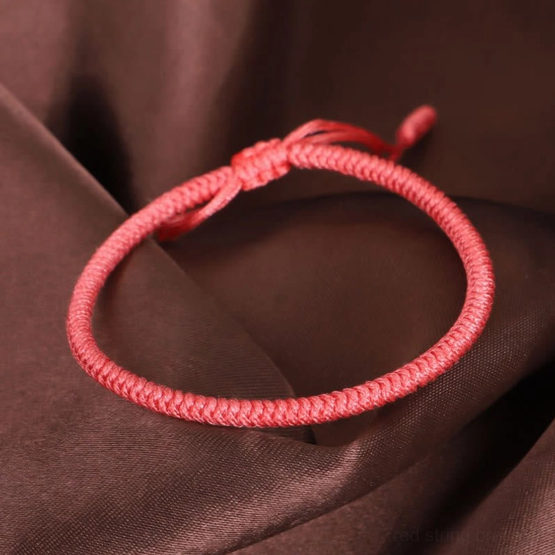 Single strand King Kong knot bracelet deep rose pink tight woven texture dark satin background