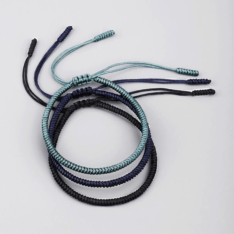 Loose tibetan amulet bracelets showing individual strands and knot structure