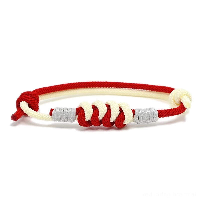 Red and white King Kong knot braided string bracelet with copper fasteners, flat lay top view