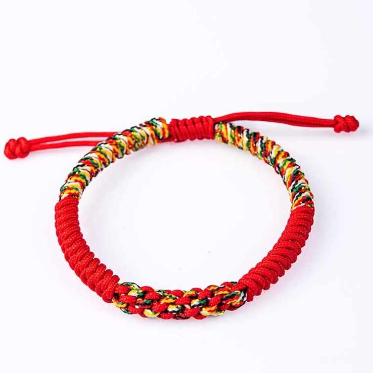 Tibetan King Kong Knot bracelet isolated on white background showing red cord and multicolor woven band