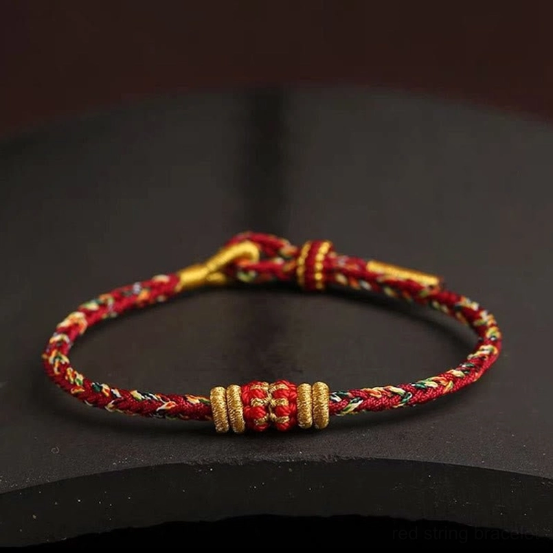 Close-up top view of handmade King Kong Knot Tibetan bracelet red and gold braided cord detail