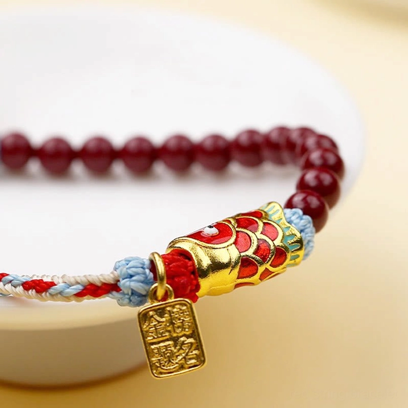 Koi fish blessing bracelet low angle view with enamel decoration and red string