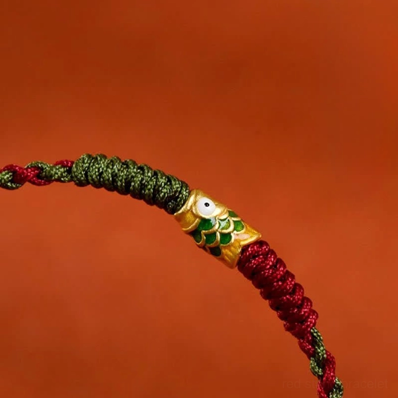 Red green koi fish bracelet showing adjustable cord length
