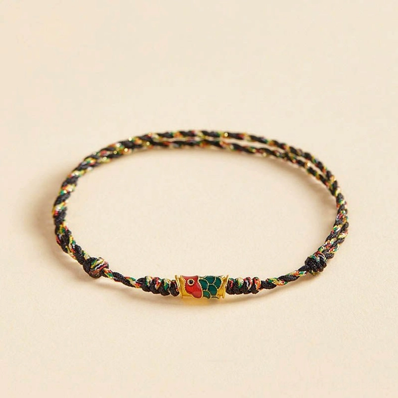 Angled view of black mixed colorful braided koi fish wealth bracelet with neat woven texture