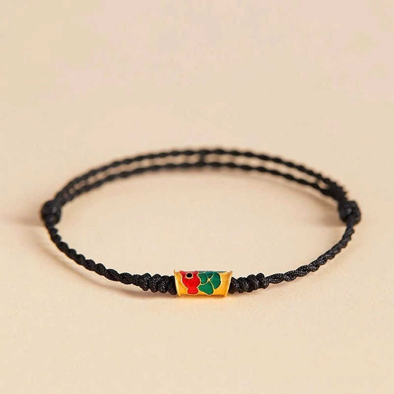 Simple black koi fish red string bracelet handcrafted minimalist design on neutral background