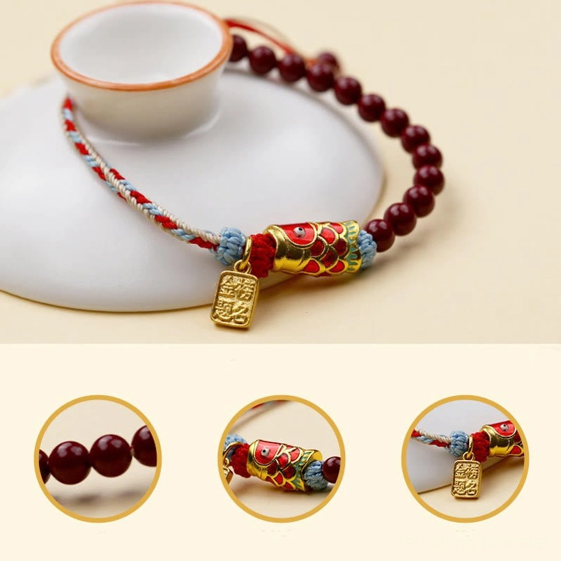 Adjustable cinnabar koi fish bracelet detail close-up with enamel charm and braided rope