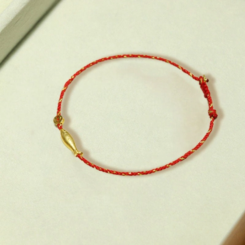 Single koi fish red string bracelet with gold buckle closure detail shot