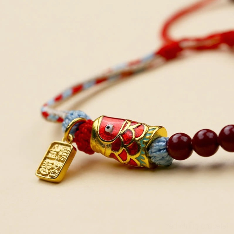 Koi fish charm close-up enamel pendant with gold accents and cinnabar beads