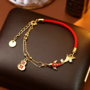 Koi fish gourd charm red string wealth bracelet with gold-plated chain and rhinestone - top-down view