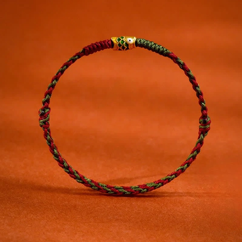 Red and green twisted cord koi fish lucky bracelet flat lay top view