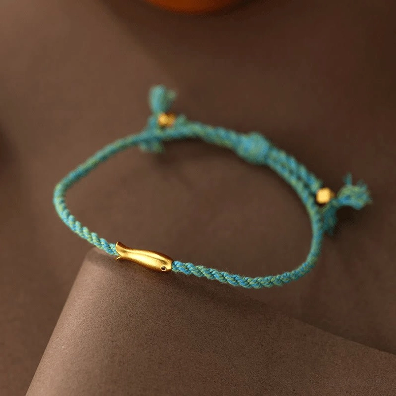 Koi fish luck rope bracelet side view showing braided cord detail and gold metal charm knots