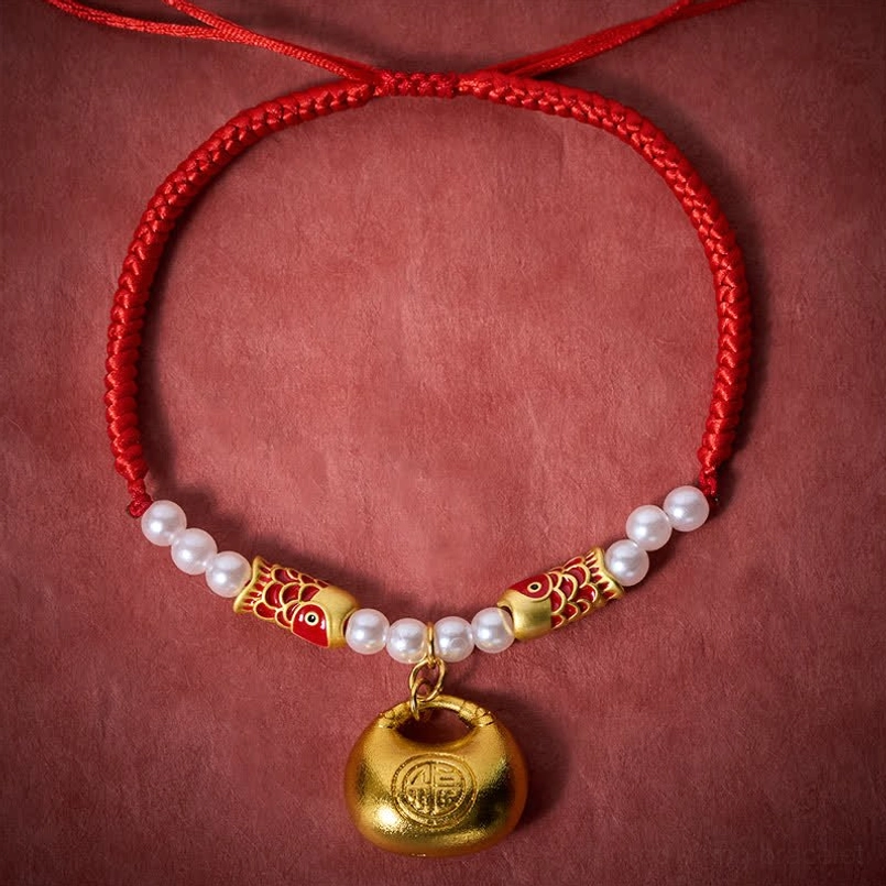 Handmade red braided pet collar flat lay with pearl beads, koi charm, and gold Fu pendant