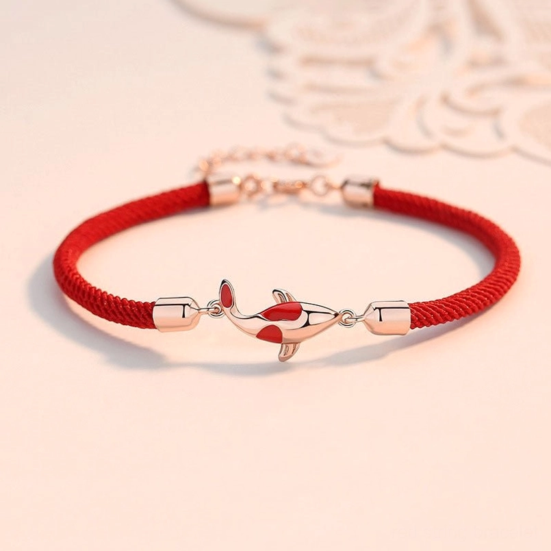 Rose gold koi fish red string couple bracelet with adjustable metal chain on lace background