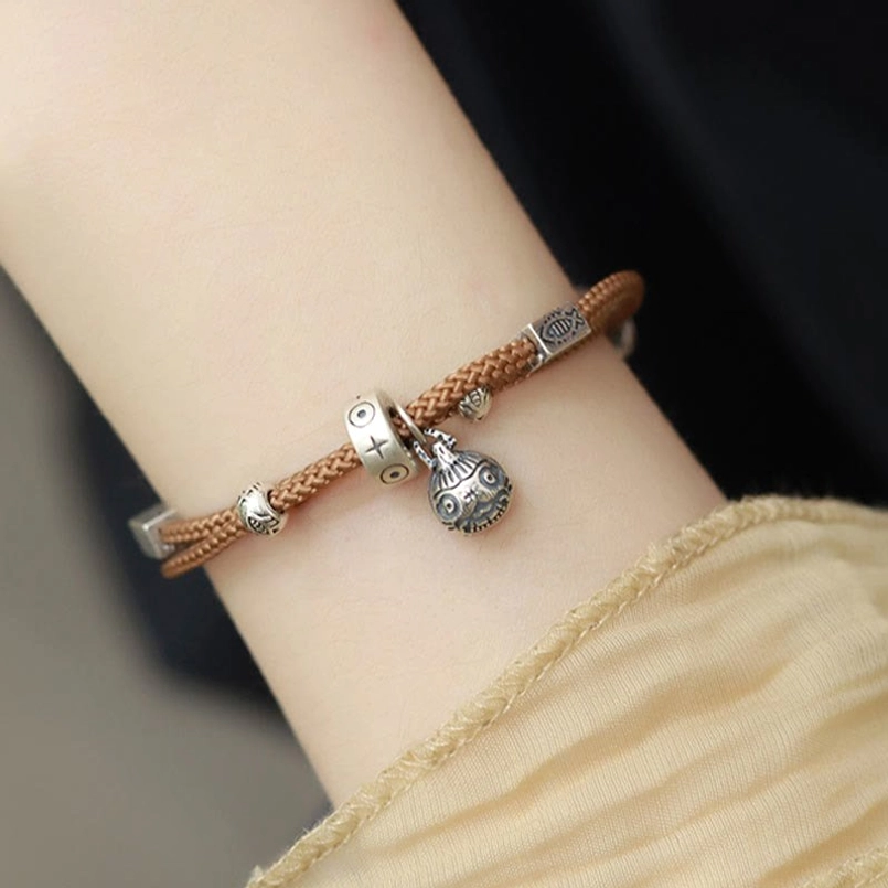 925 sterling silver koi fish charm close-up on braided red string
