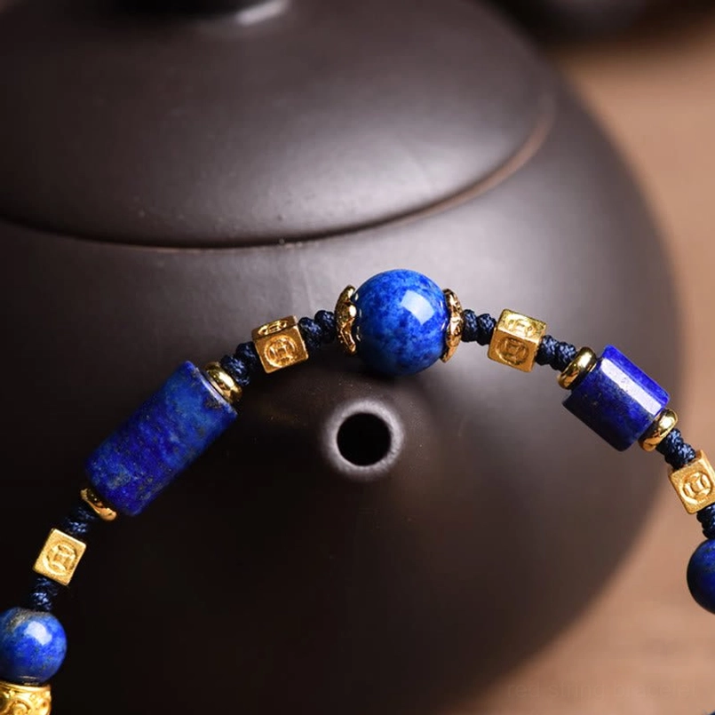 Close-up of large round lapis lazuli beads with carved metal accents