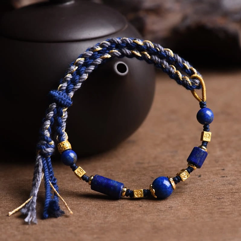 Lapis lazuli wisdom bracelet showing braided rope tassels and gold metal spacer details