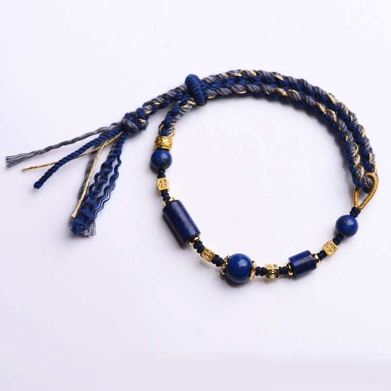 Lapis lazuli wisdom bracelet with braided tassel design on white background