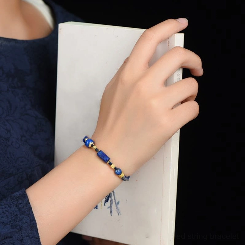 Lapis lazuli red string bracelet worn on wrist showing real wear effect