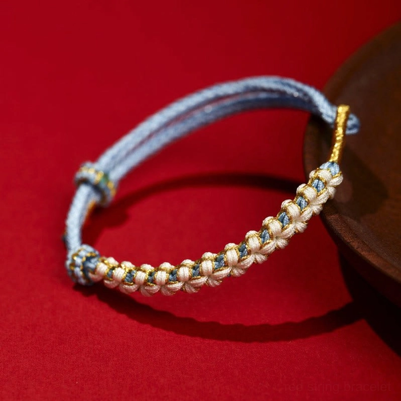 Light blue Tibetan peach blossom knot braided red string bracelet with gold accents