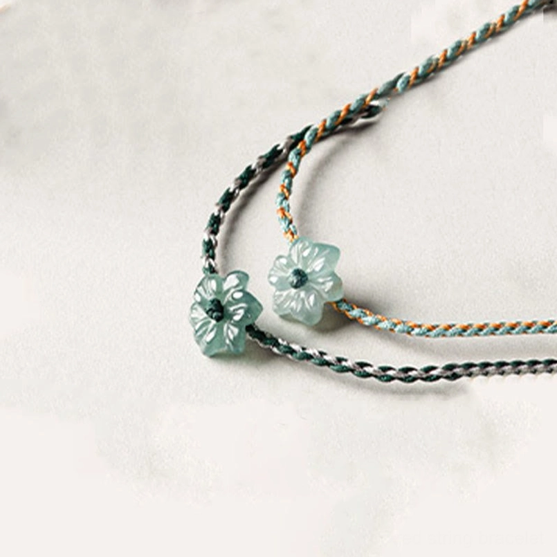 Luxury light green gold thread jade orchid braided bracelet close up