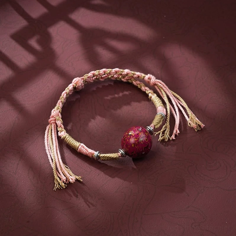 Light pink braided red string bracelet with red lacquer bead and tassels