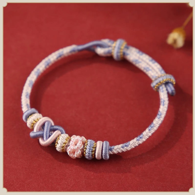 Light Purple Peach Blossom Red String Luck Bracelet Flat Lay View