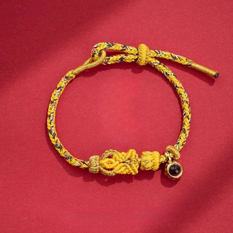 Light yellow braided Buddha knot red string bracelet with projection stone charm