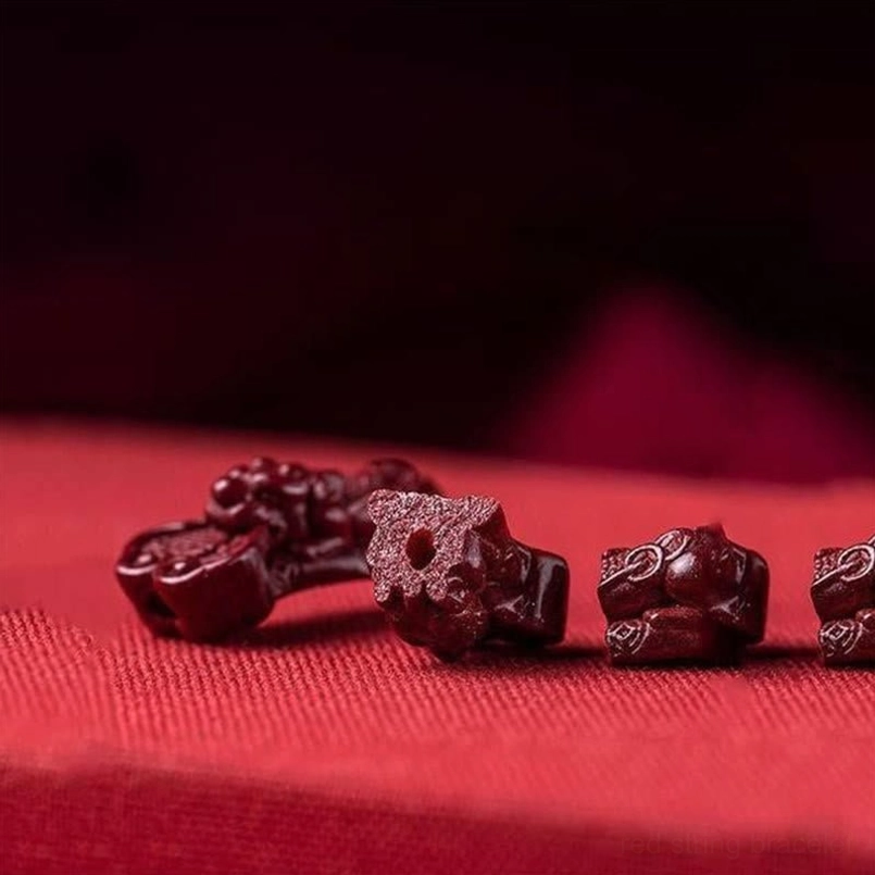 Assorted loose cinnabar fortune charms with deep red matte finish