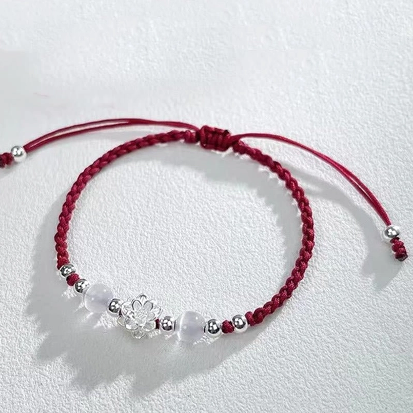 person wearing lotus red string bracelet on wrist casual daily shot