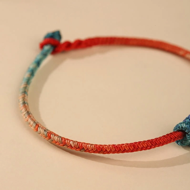 Tibetan hand-woven bracelet with adjustable sliding knot and decorative end knot detail
