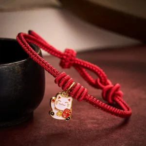 Handmade Lucky Cat Red String Bracelet with Fu Character on Dark Wooden Surface