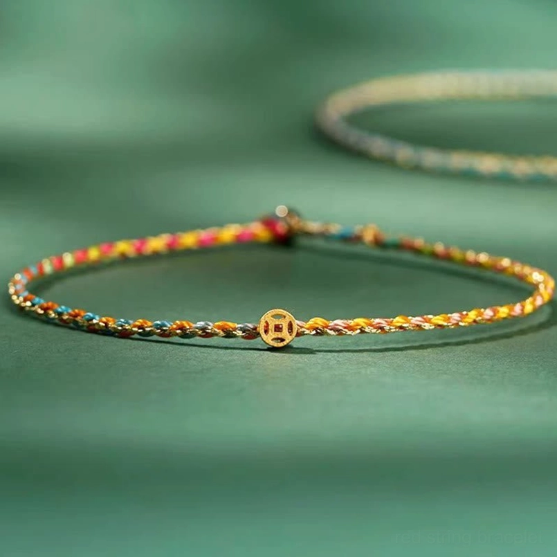 Braided lucky coin bracelet with multicolor woven strands and gold coin pendant in angled view