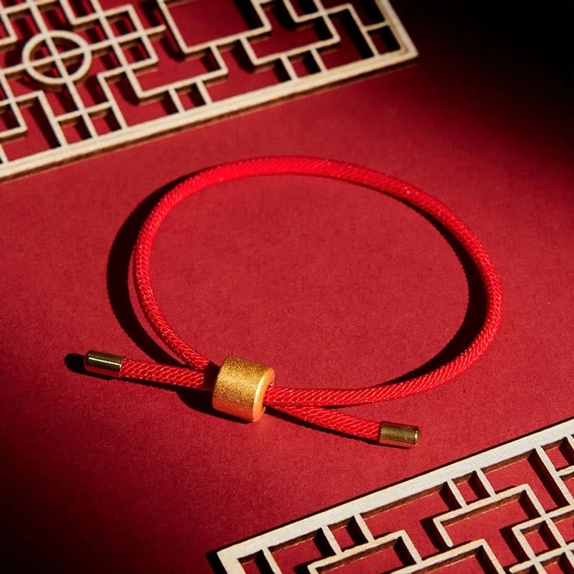 Lucky red string bracelet on traditional Chinese red tabletop lattice decor