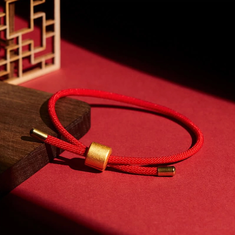 Lucky red string bracelet placed on wooden display block red tabletop