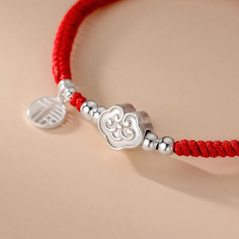Macro close up of polished 925 sterling silver Fu character and auspicious cloud charms