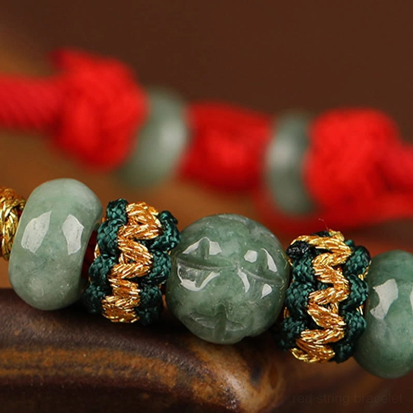 Macro close up of carved jade abacus bead and woven knot bracelet details