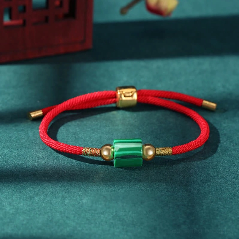 Malachite Tibetan protection bracelet with red braided rope and copper gold hardware