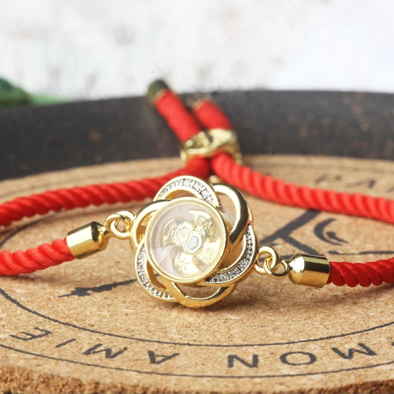 Matching pair of rotatable plum windmill red string bracelets top down view