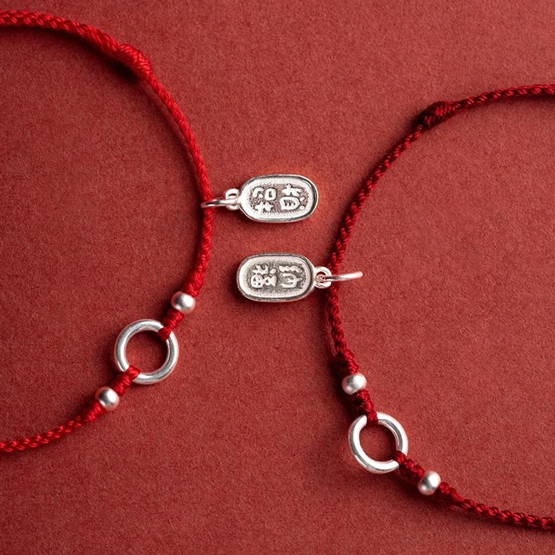pair of matching 925 sterling silver red string bracelets side view