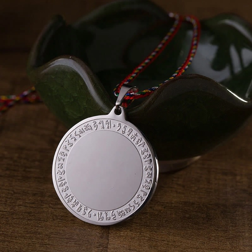 Medicine Buddha mantra necklace lifestyle wear shot with protective red string and titanium steel pendant