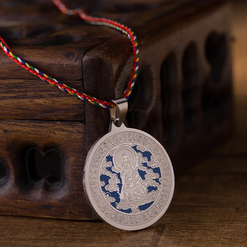 Medicine Buddha silver finish mantra necklace with blue enamel engravings and braided rope
