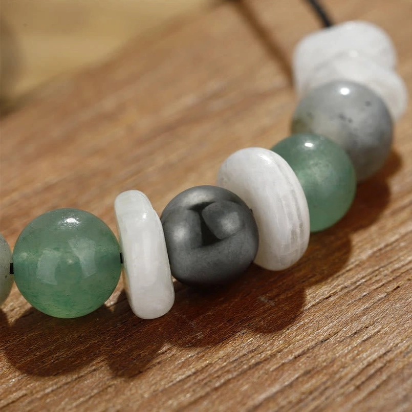 Close-up detail of menopause healing bracelet gemstones showing labradorite iridescence and moon stone texture