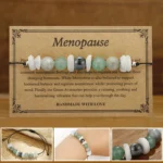 Menopause healing bracelet with white moonstone labradorite aventurine and vintage greeting card on wooden surface