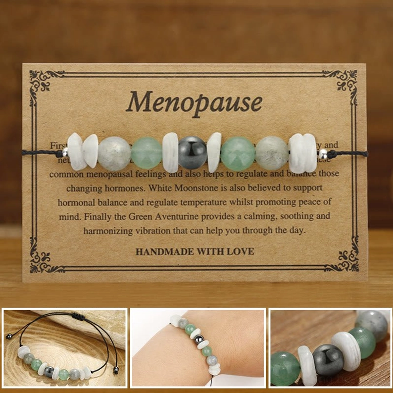 Menopause healing bracelet with white moonstone labradorite aventurine and vintage greeting card on wooden surface