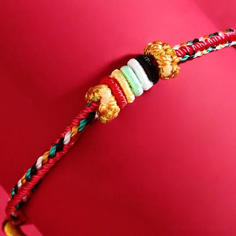 Metal element white braided five elements feng shui lucky bracelet with spacer beads on red background