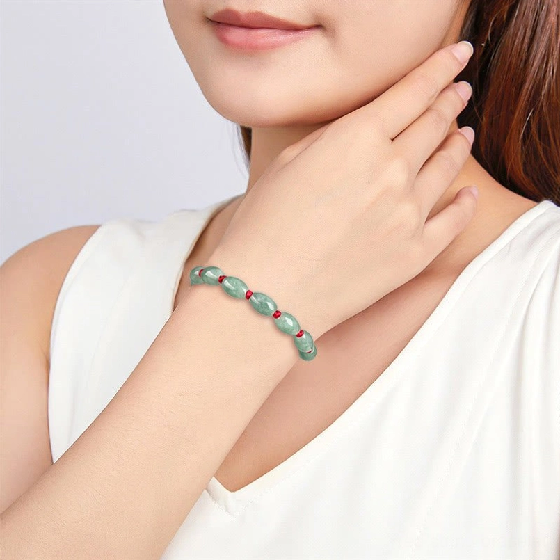 Lifestyle shot of jade luck red string bracelet worn on left wrist